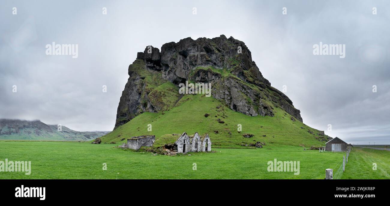 Old Run Down Farm by Rock Outcrop, South Iceland, Iceland Stock Photo