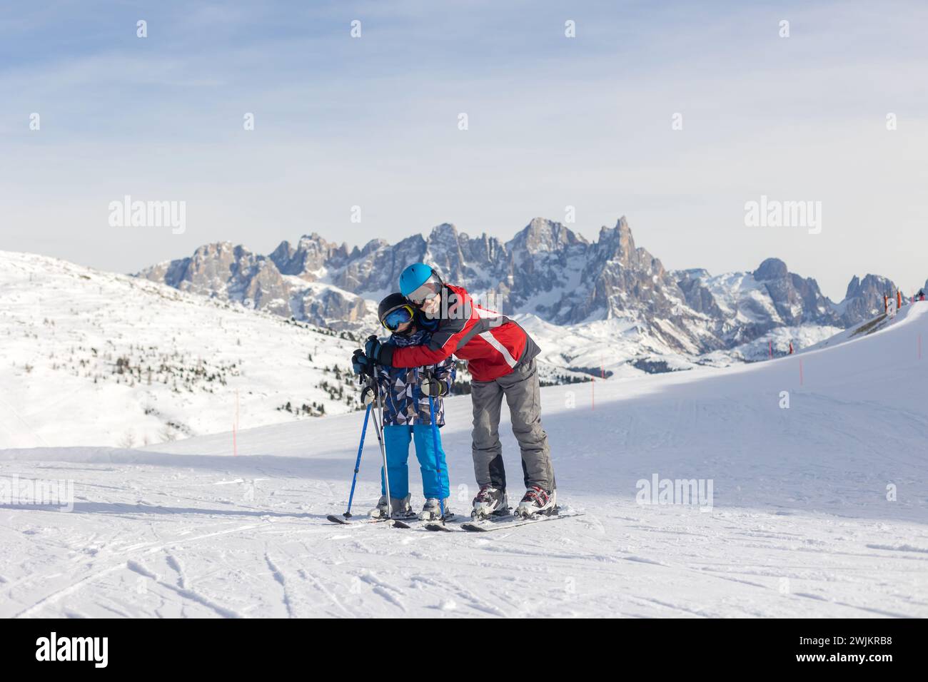 Children and adults, happy family in winter clothing at ski vacation, skiing, wintertime Stock Photo