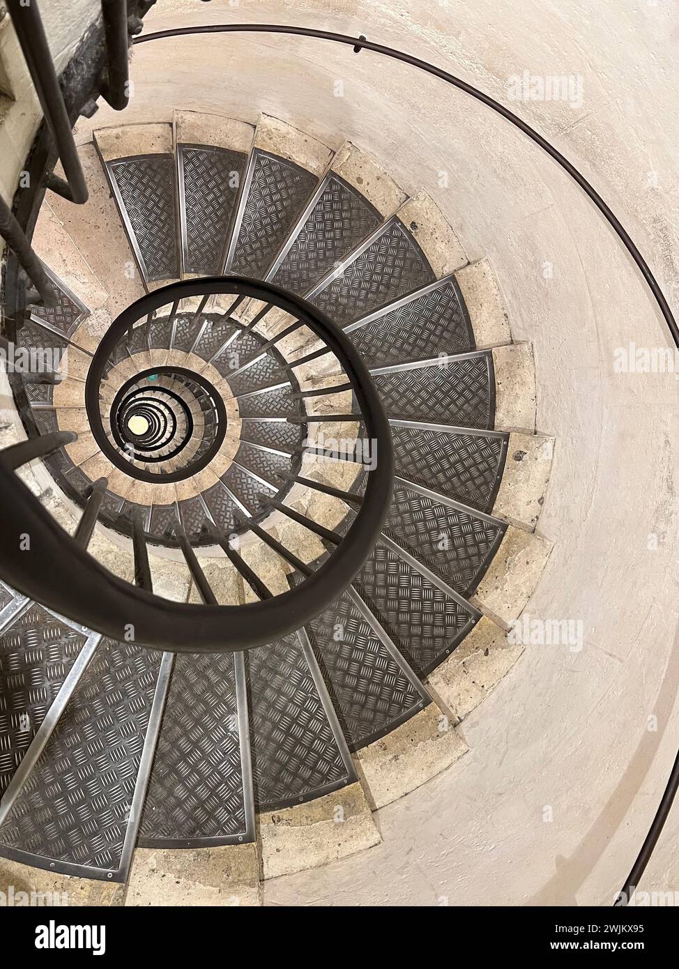 Never ending winding staircase with black railing Stock Photo - Alamy