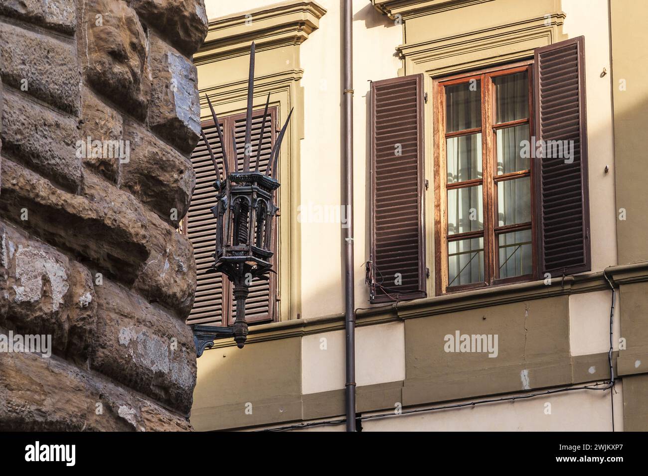 FLORENCE, ITALY - SEPTEMBER 12, 2018: This is a preserved medieval lamp on the corner of an old house. Stock Photo