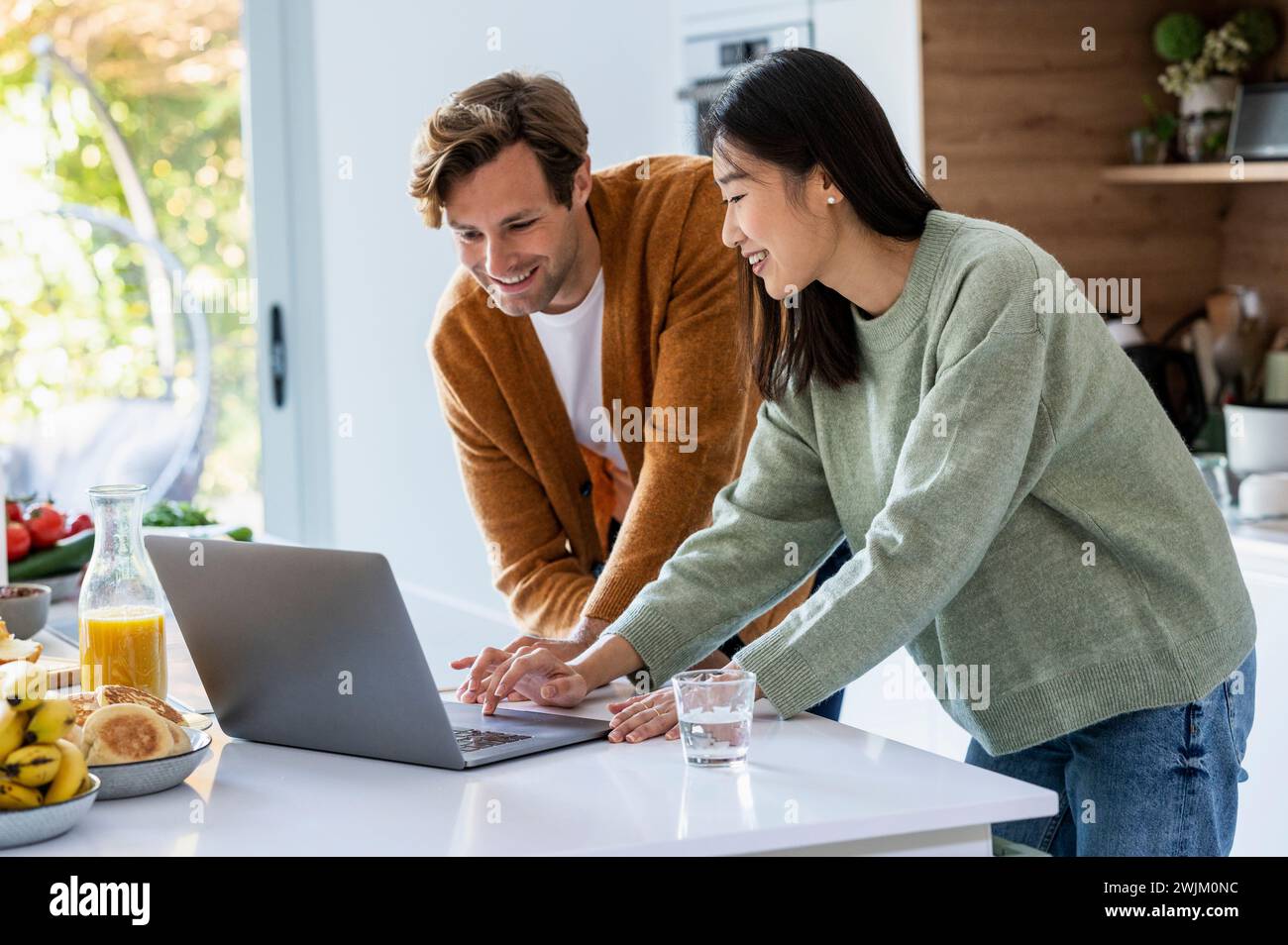 Adult couple using laptop hi-res stock photography and images - Alamy
