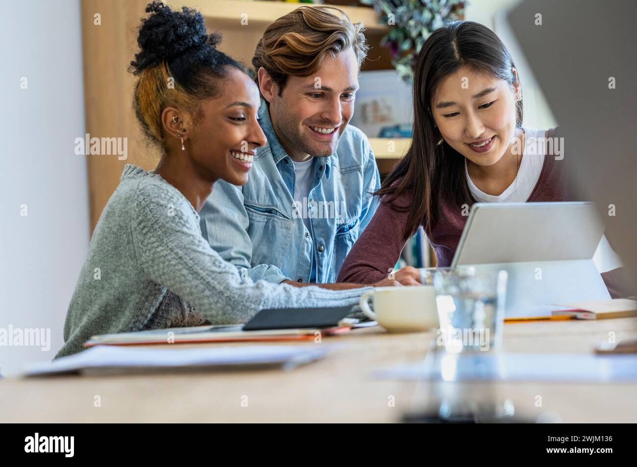 Coworkers using having a web conference together on digital tablet Stock Photo