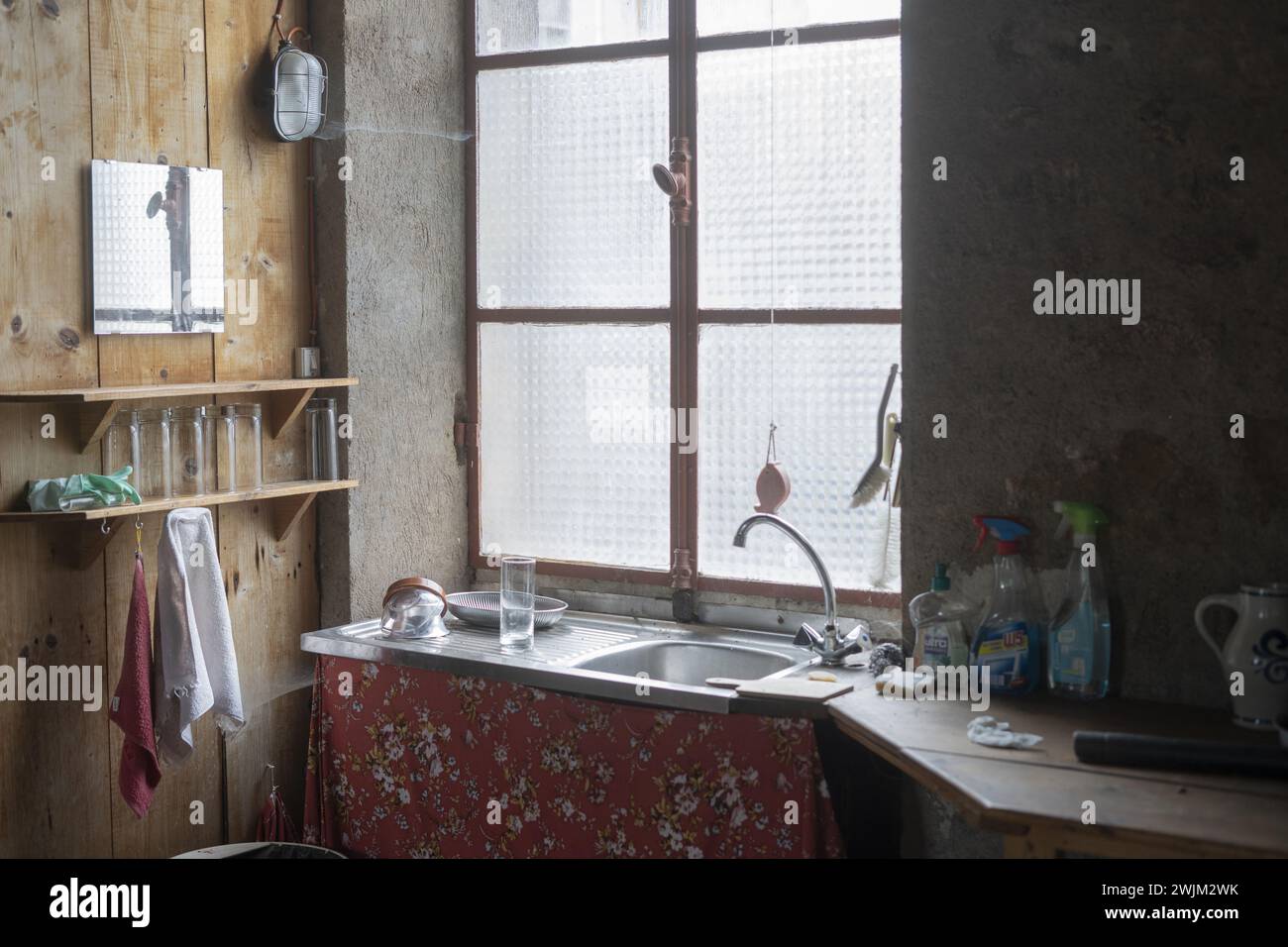 Empty kitchen with light coming through main window Stock Photo