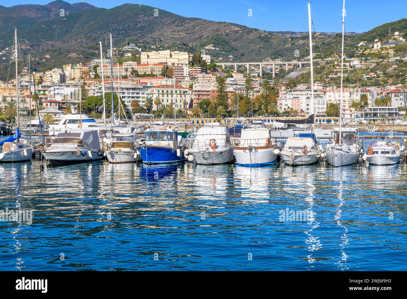 Sanremo town on the Italian Riviera - Riviera Ligure, with the beautiful marina in the foreground. Shot from the harbour arm called Molo Sud. Stock Photo