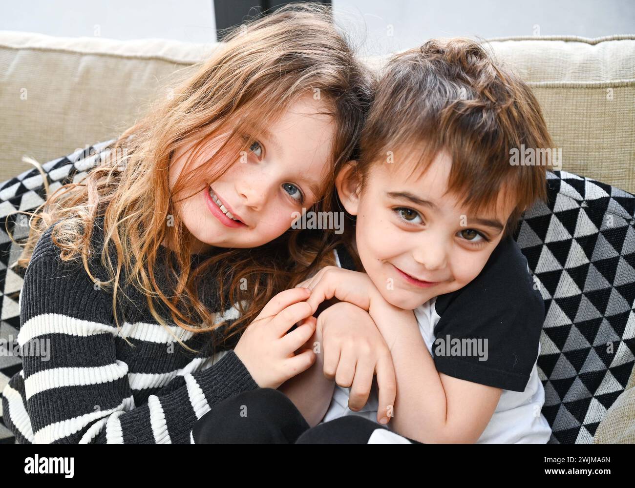 Loving seven year old girl with her four year old brother Stock Photo