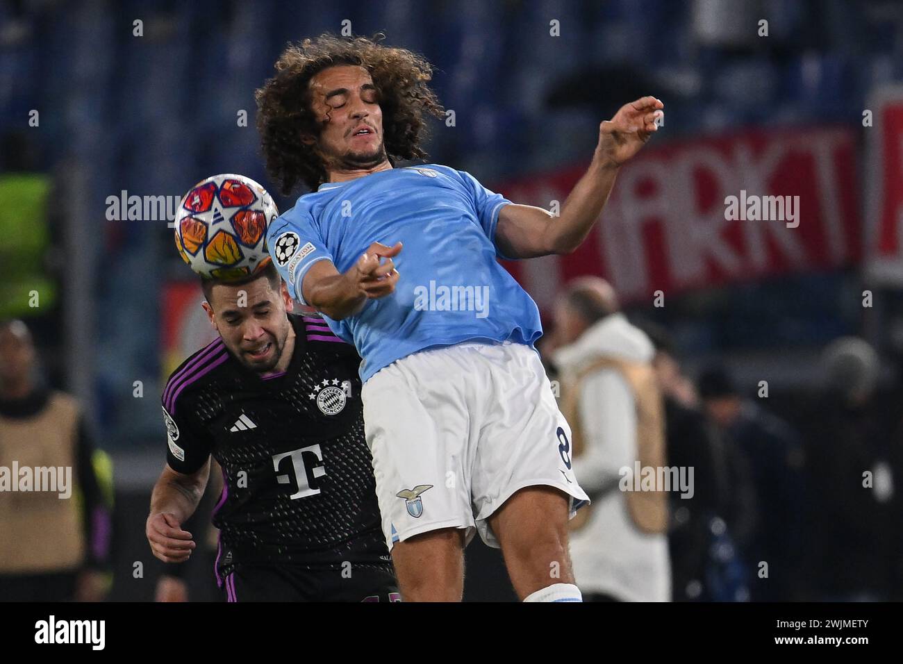 Rome, Italy. 14th Feb, 2024. Raphael Guerreiro of F.C. Bayern Munchen and Matteo Guendouzi of S.S. Lazio during the round of 16 of the UEFA Champions League between S.S. Lazio vs F.C. Bayern Munich on 14 February 2024 at the Olympic Stadium in Rome, Italy. Credit: Independent Photo Agency/Alamy Live News Stock Photo