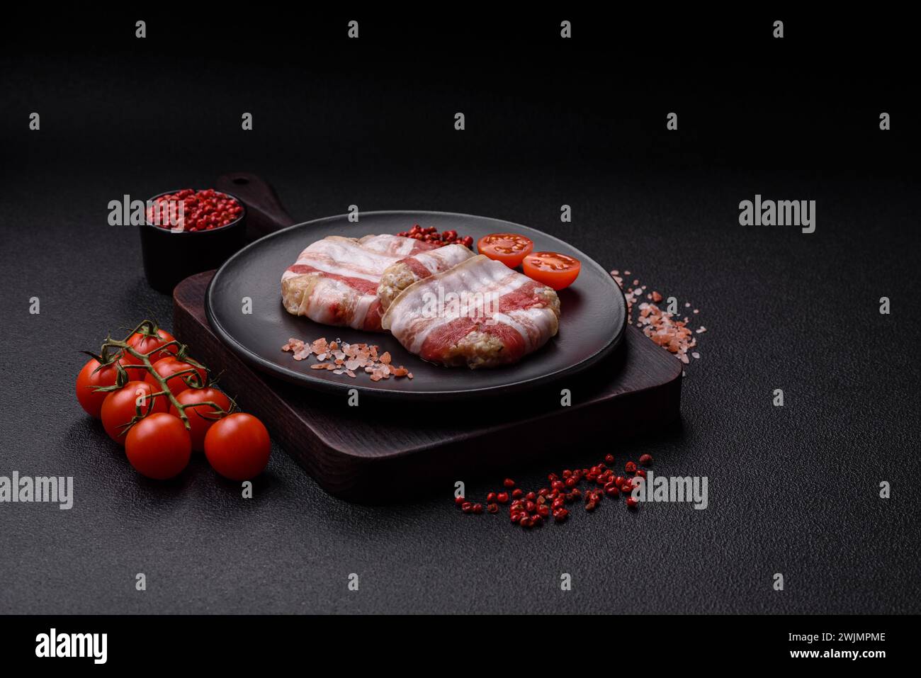 Round minced chicken or pork cutlet wrapped in bacon with salt, spices ...