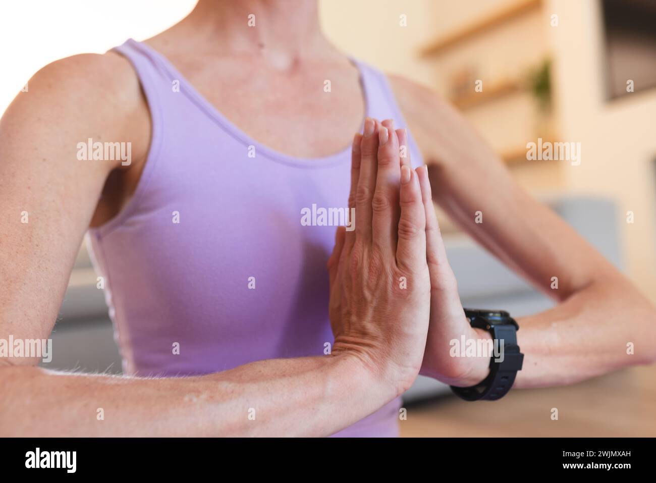 Caucasian woman practices yoga at home, with copy space Stock Photo