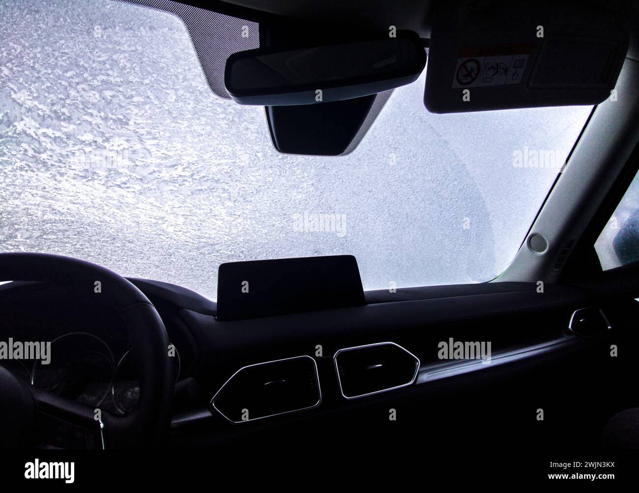 Frost covered windshield seen from Inside car. Safe driving on winter concept Stock Photo Alamy