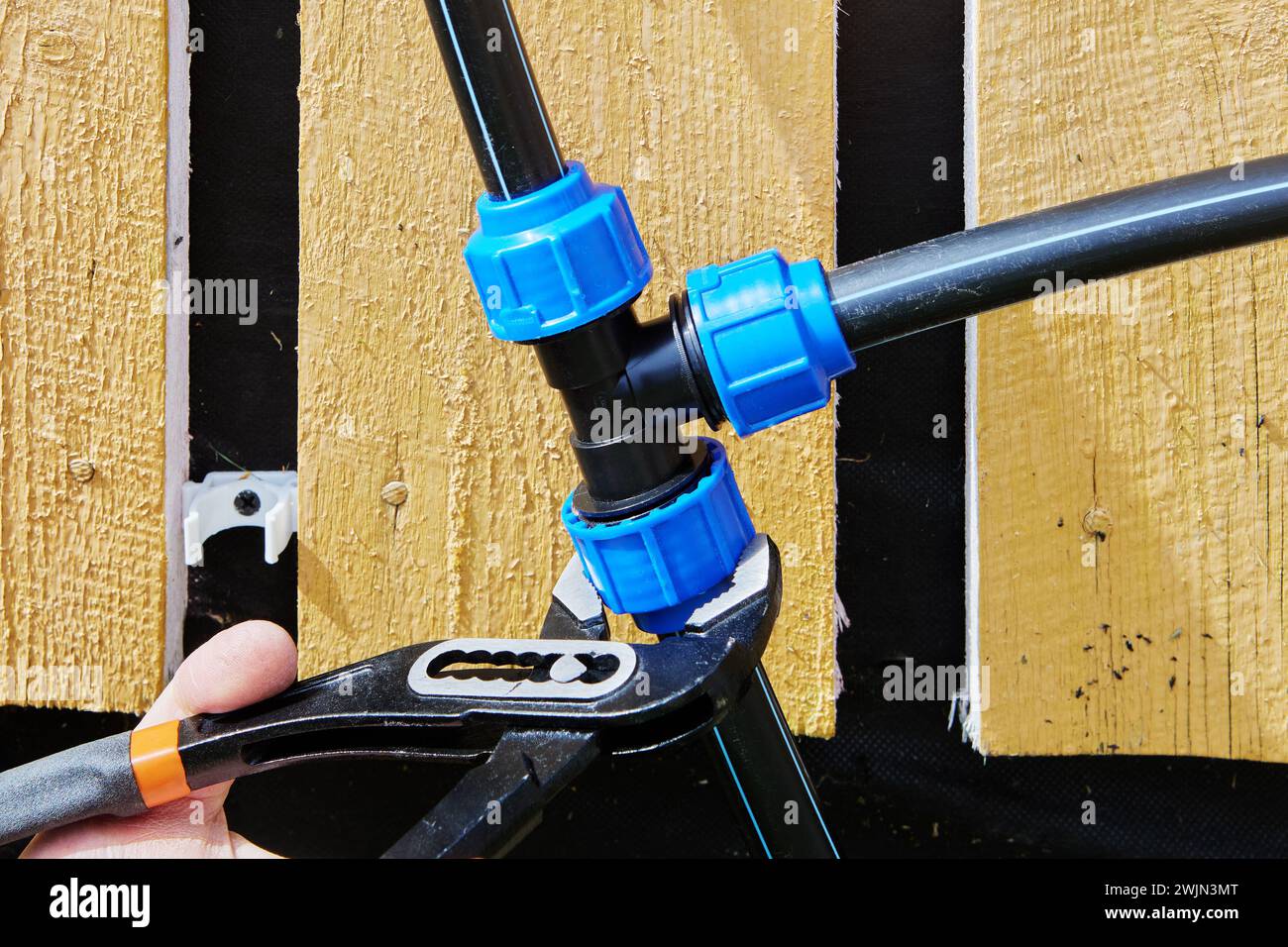 Using water pipe pliers to tighten clamp nut of compression tee fitting