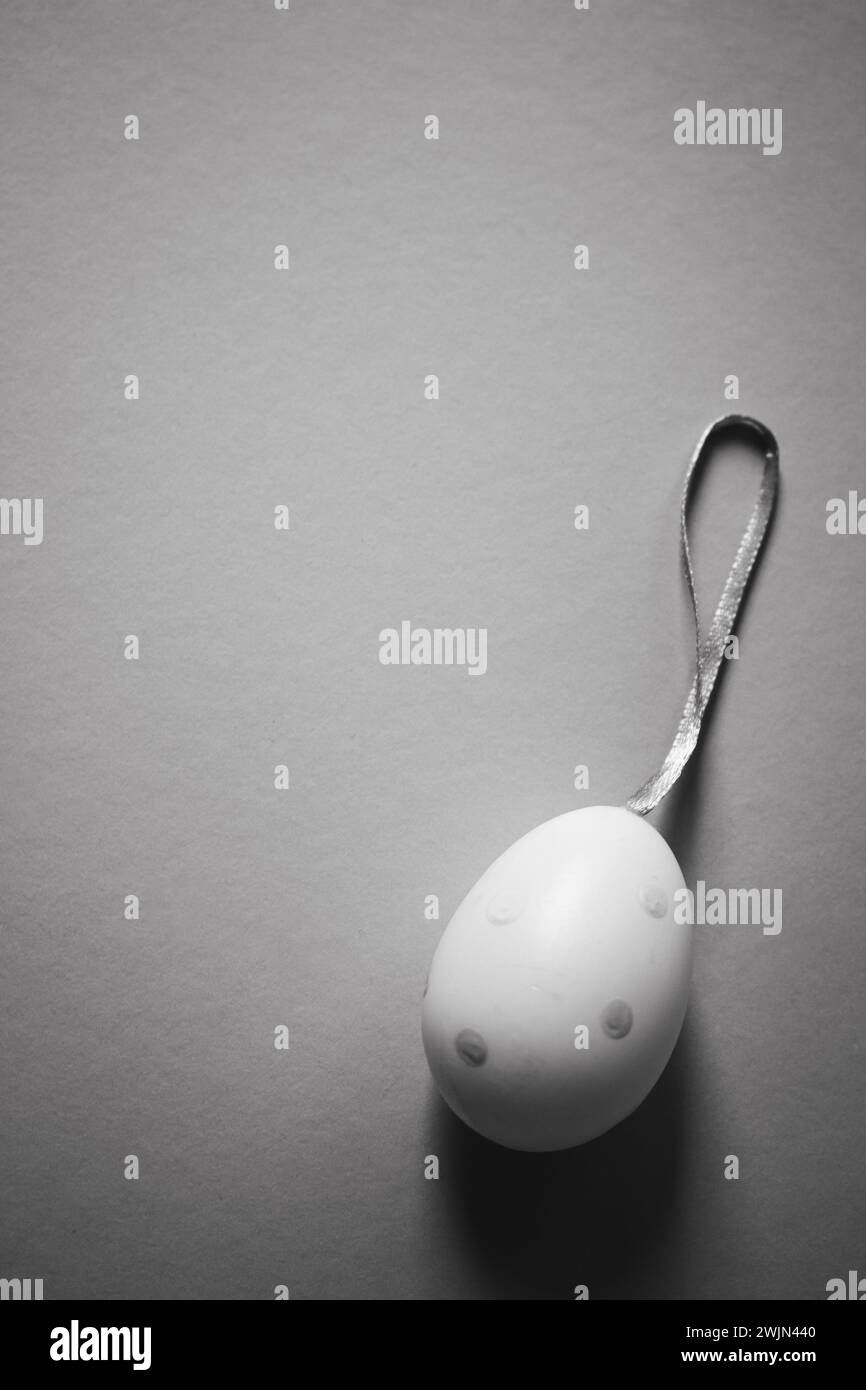 Easter egg on white background, monochrome. Easter egg with copy space. Easter banner. Traditional spring holiday. April concept. Stock Photo