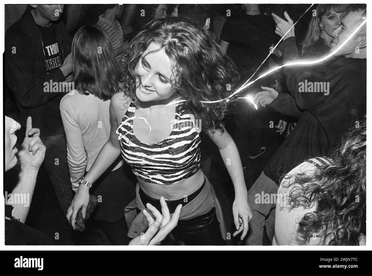A woman in an animal print top lost in music dancing in Clwb Ifor Bach in Cardiff Wales in January 1996. Photo: Rob Watkins. Stock Photo