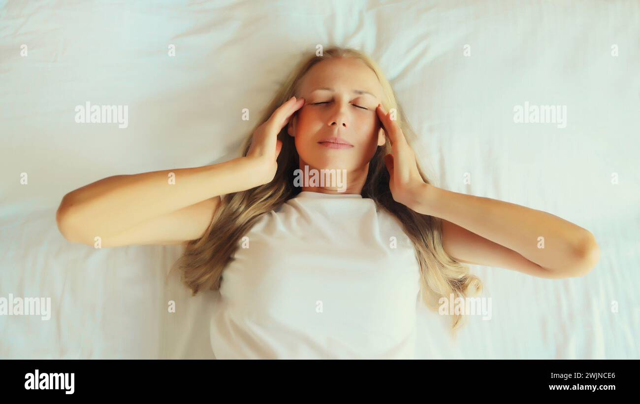 Upset exhausted woman with headache, pain tension in the head, suffers from migraine lying on