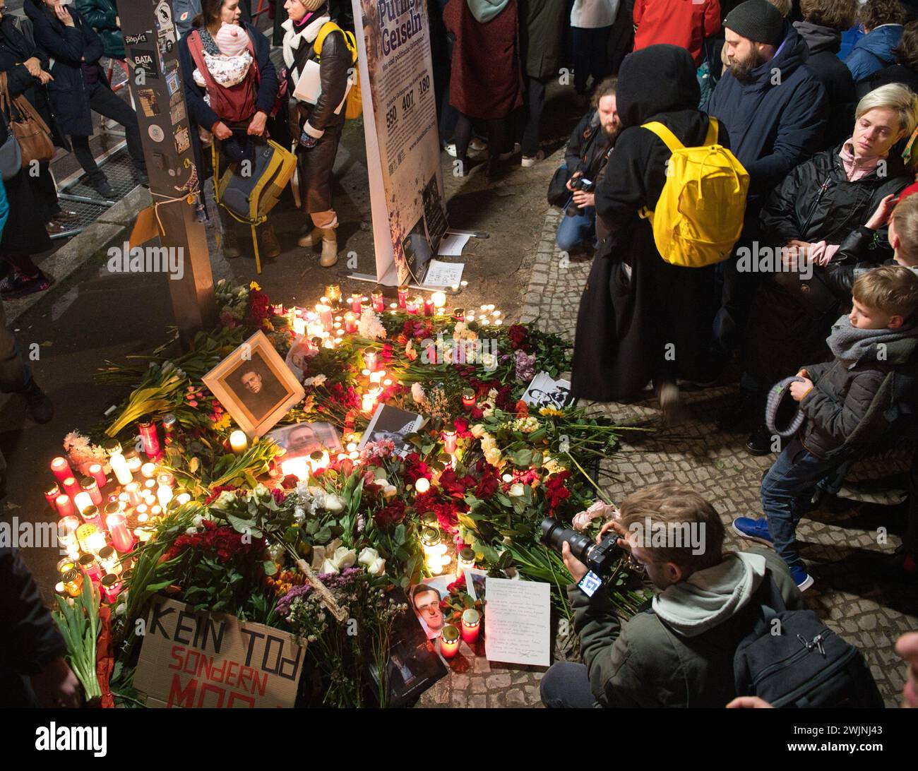 Berlin, Germany. 16th Feb, 2024. Flowers, candles and photos can be seen at a memorial service for Russian dissident Navalny, who died unexpectedly today, on the central island in front of the Russian embassy. More than 1000 people also protested against the Russian regime. Credit: Paul Zinken/dpa/Alamy Live News Stock Photo