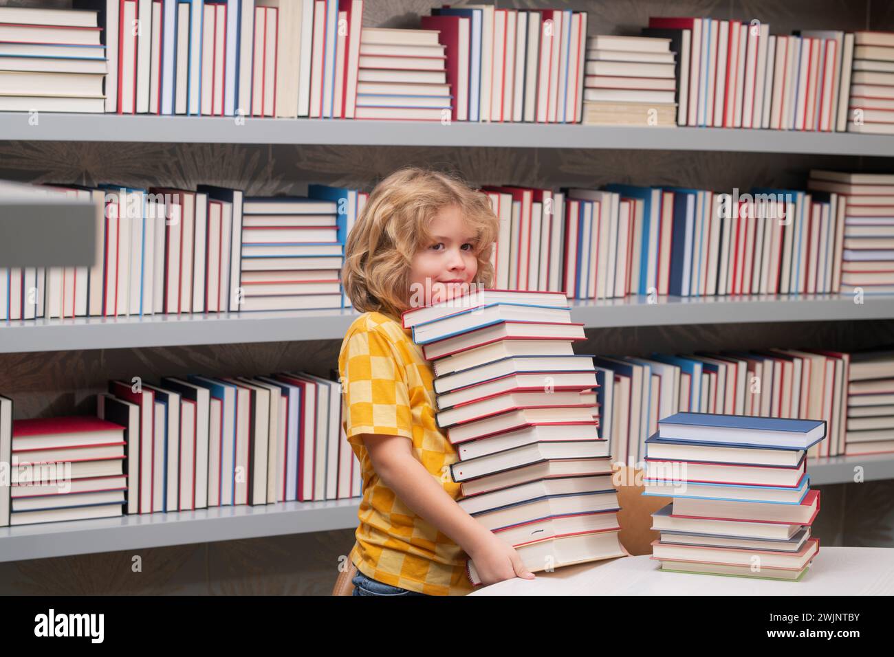 School boy. Schoolboy reading book in library. Kids learn to read ...