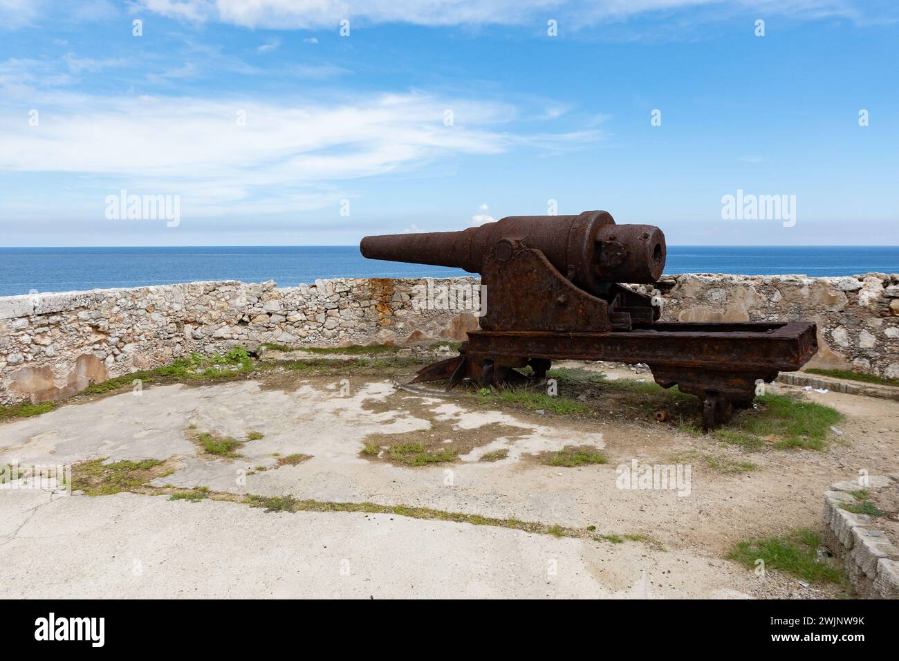 Cannon near rampart wall of Castillo de los Tres Reyes del Morro castle in Havana, Cuba Stock Photo