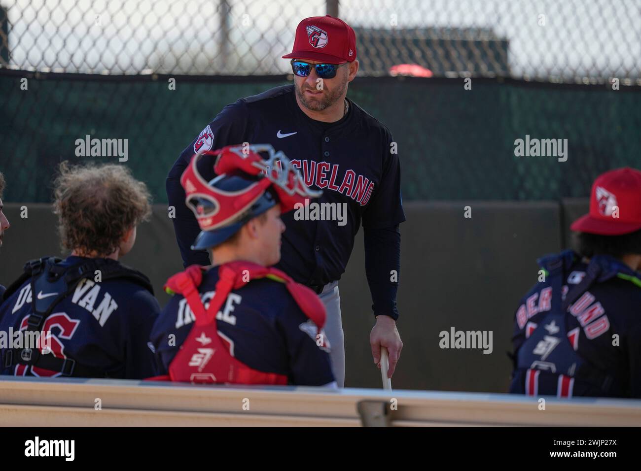 Cleveland Guardians manager Stephen Vogt, top,talks with catchers