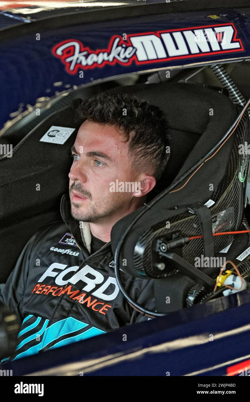 Race car driver and actor Frankie Muniz sits in his car before a