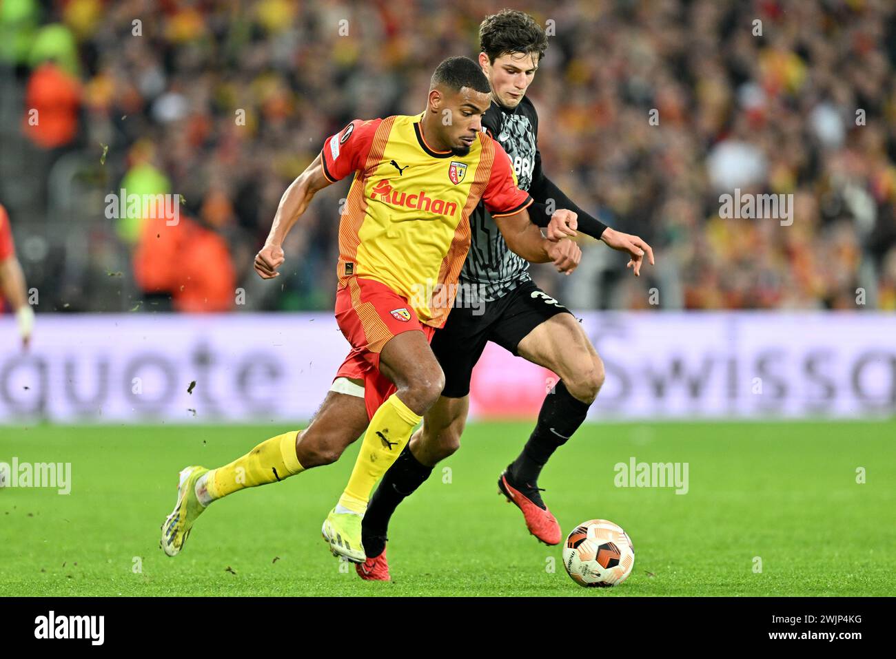 Andy Diouf (18) of RC Lens fighting for the ball with Merlin Röhl (34) of Freiburg during the Uefa Europa League play-off -first leg game in the 2023-2024 season between Racing Club de Lens and SC Freiburg on February 15 , 2024 in Lens, France. (Photo by David Catry / Isosport) Stock Photo