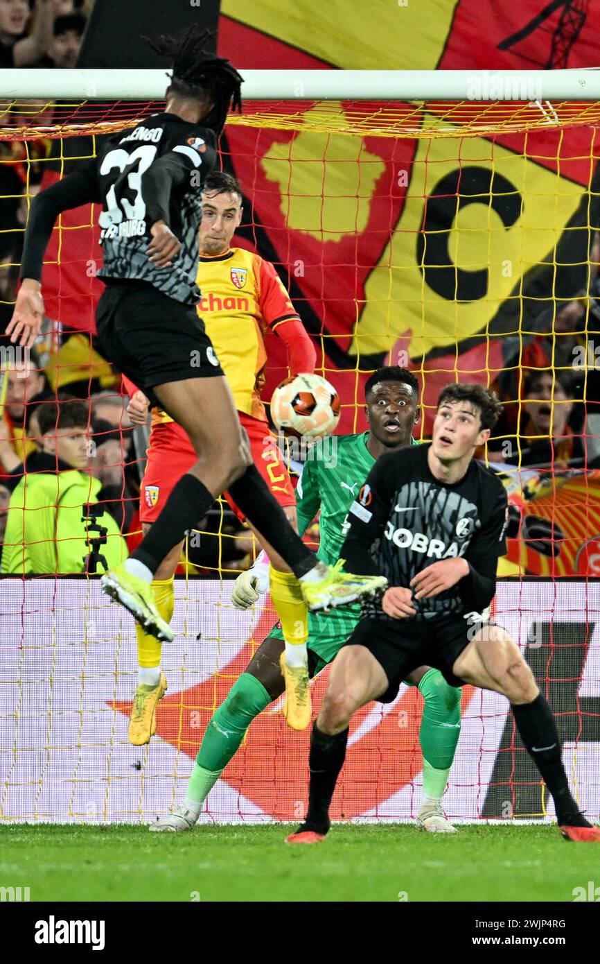 goalkeeper Brice Samba (30) of RC Lens watching the action of Jordy Makengo (33) of Freiburg, Ruben Aguilar (2) of RC Lens and Merlin Röhl (34) of Freiburg in front of him during the Uefa Europa League play-off -first leg game in the 2023-2024 season between Racing Club de Lens and SC Freiburg on February 15 , 2024 in Lens, France. (Photo by David Catry / Isosport) Stock Photo