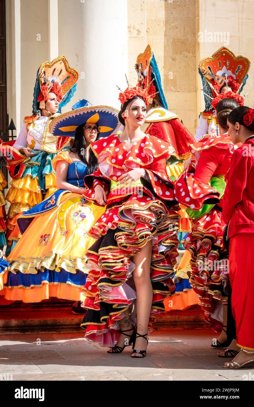 Women in colorful dresses at Malta Carnival 2024, Valletta, Malta Stock