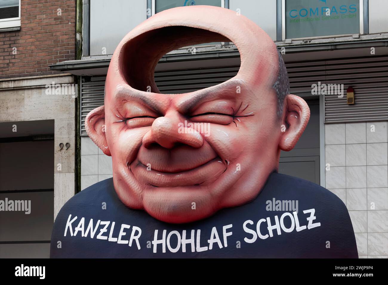 Chancellor Olaf Scholz as an airhead, papiermâché figure, satirical