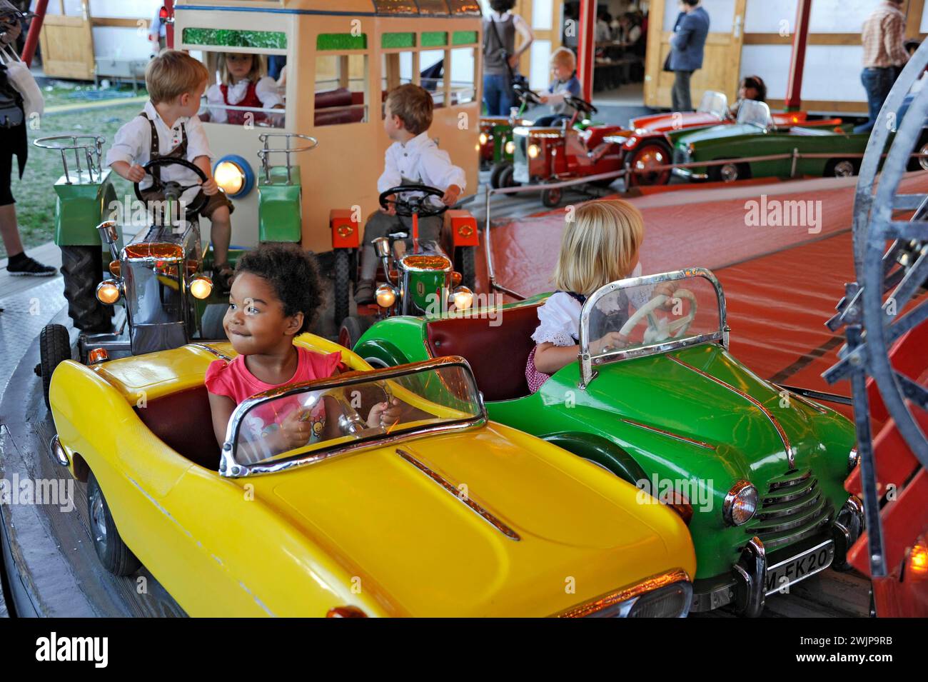 Boys and girls on car in carousel, old, historic Oktoberfest, Oktoberfest, Munich, Upper Bavaria, Bavaria, Germany Stock Photo