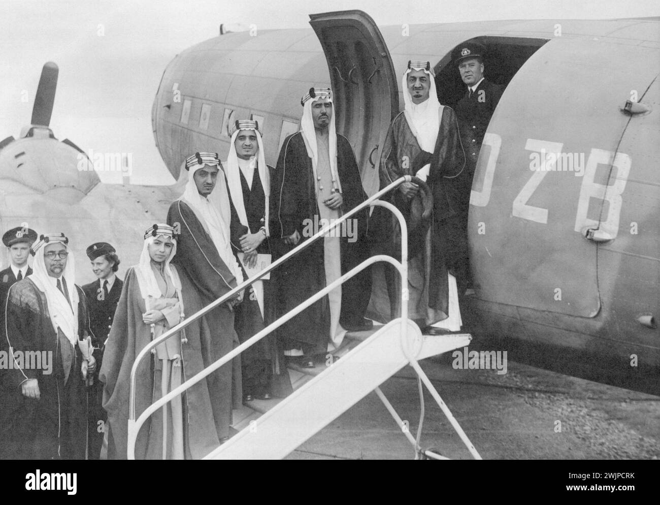 The Amir Faisal about to board the plane at Hern Airport, followed by his retinue. Departure of the King of Arabia. He was carried by the overseas Airways (British) from the Airport at Hran? Hants. By Command of the King, Colnel the Lord Manners (Deputy Lieutenant of Hampshire) was in attendance at Hern Airport, near Christchurch, upon the departure of the Amir Faisal, the and the Amir Nawaf of Saudi Arabia. September 1, 1945. (Photo by Fox Photos). Stock Photo