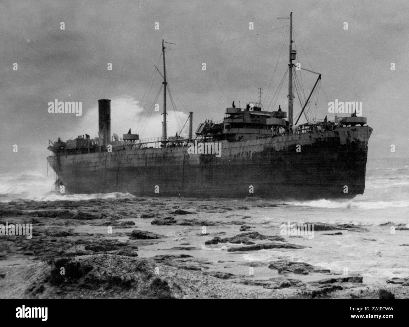 Five sailors still remained aboard this allied steamer, wrecked in a gale on the Australian coast, when this photo was taken. Eventually all hands were saved but on the first day of rescue efforts, four Australian soldiers lost their lives. November 15, 1943. Stock Photo