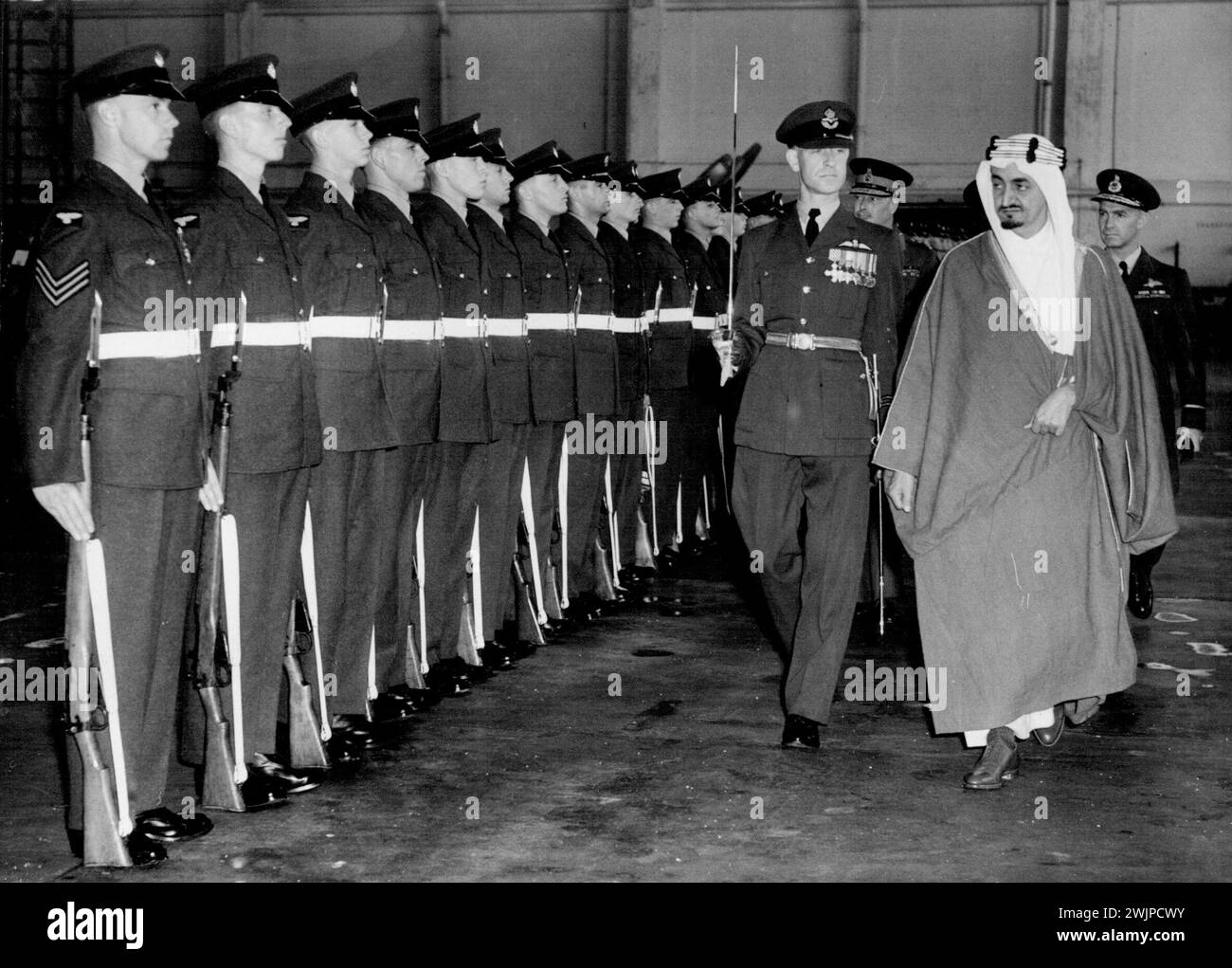 Prince from Arabia -- With the Dude of Gloucester who was there to Receive him on Behalf of the King, the Emir Feisal Inspects the R.A.F. Guard of Honour on his Arrival at Northolt Airport this Morning. One of the More Spectacular Arab Princes?, Emir Feisal, second son of king IBN Saud of Saudi Arabia, Came to London to-day. As his Country's Foreign Minister, he has Arrived on an Official Ten-day Visit as guest of the British Government. Tomorrow August 8th, he will dine with Mr. Morrison, British Foreign Secretary, at his Carlton Gardens Residence. August 7, 1951. (Photo by Paul Popper). Stock Photo