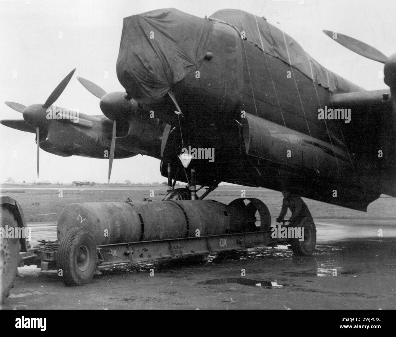 R.A.F. is 12,000 Lb, Bomb -- Preparing to load a 12,000 lb. bomb on to a waiting Lancaster. R.A.F. Bomber Command has been dropping an ever bigger bomb on industrial targets in occupied France and Germany. The new 12,000 pounder has been used with devastating effects on factories working for the enemy. March 11, 1944. (Photo by British Official Photograph). Stock Photo