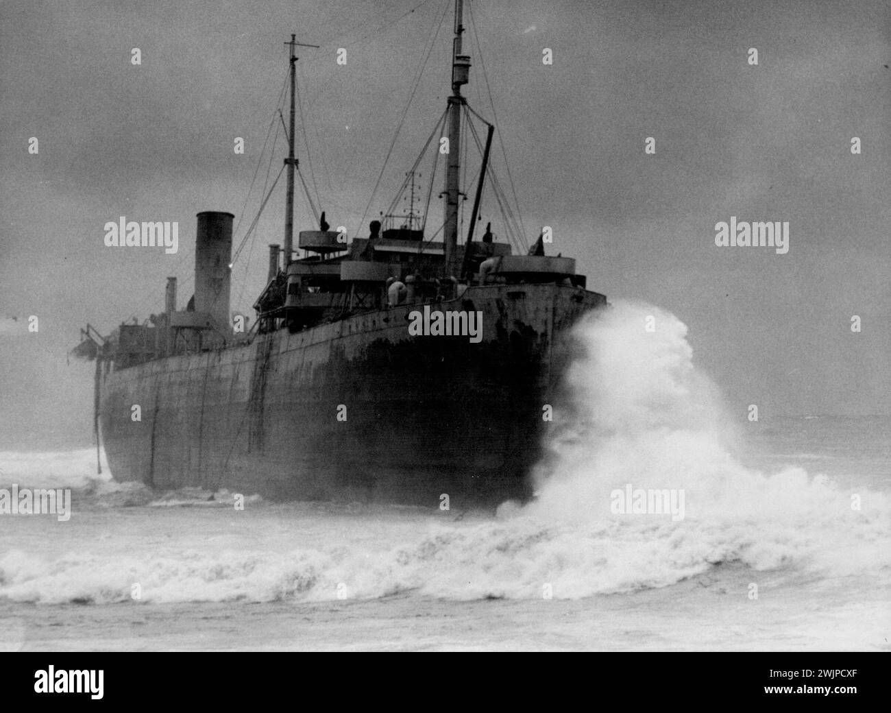Five Sailors still remained aboard this American steamer, wrecked moments ago in a gale on the Australian coast, when this photo was taken. Eventually all hands were saved but four Australian Soldiers assisting in the rescue were drowned. November 15, 1943. (Photo by Baden Herbertson Mullaney/Fairfax Media) Stock Photo