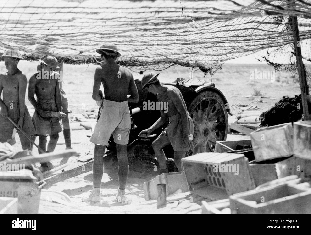 Crew of one of the 'bush' artillery guns preparing for action at Tobruk. November 22, 1941. (Photo by Australian Imperial Force Photo). Stock Photo