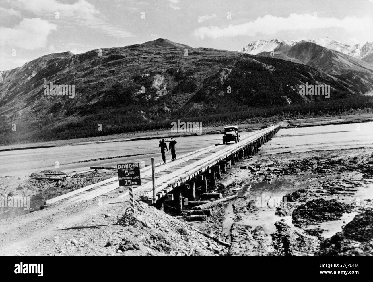 U.S. Highway To Alaska -- U.S. Army engineers built this permanent wooden bridge in three weeks as part of the Alcan Highway linking the U.S. and Alaska. The timber for the bridge was cut from the virgin forests through which the highway was routed. May 01, 1950. Stock Photo