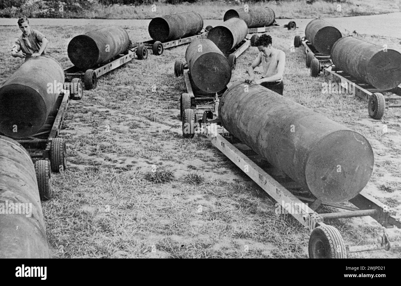 The R.S.F.'S Four Thousand Pound Bomb. -- A line-up of 4,000lb. bombs waiting to be unloaded on to Lancaster bombers. First official photographs of the R.A.F.'s 8,000lb and 4,000lb. bombs, are now released. Their weight has been felt with devastating effect on enemy targets in Italy and Germany. November 1, 1943. (Photo by Department Of Information, Commonwealth of Australia). Stock Photo