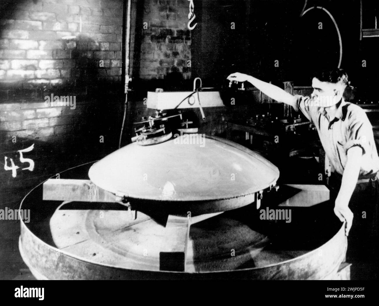 The surface of the reflector is here being ground into accurate shape. July 14, 1942. Stock Photo