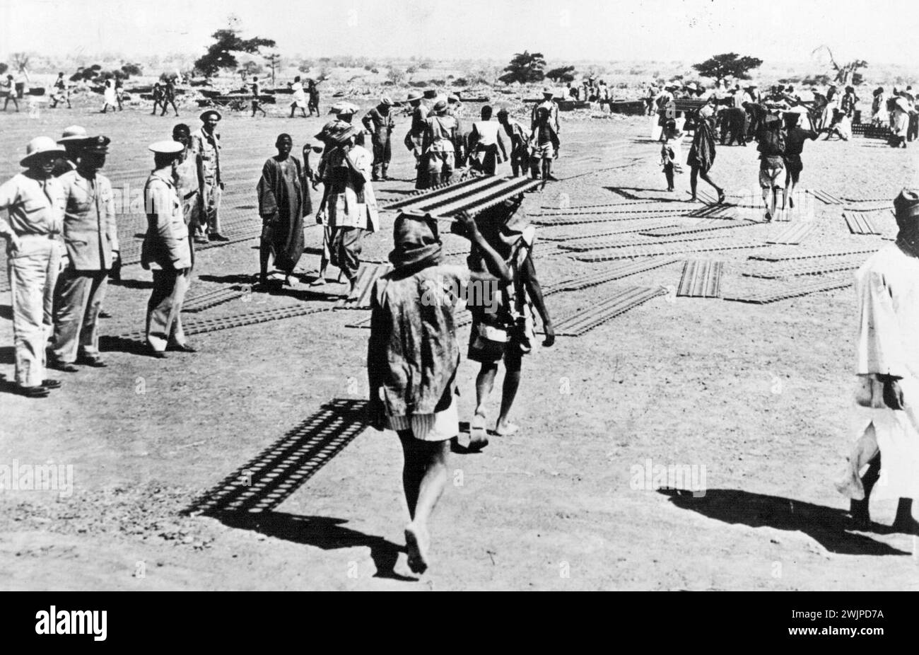 Americans In Dakar -- American Army engineers (left) supervise construction of a mile long runway for a new air base at Dakar, French West Africa. January 1, 1943. (Photo by U.S. Office of War Information). Stock Photo
