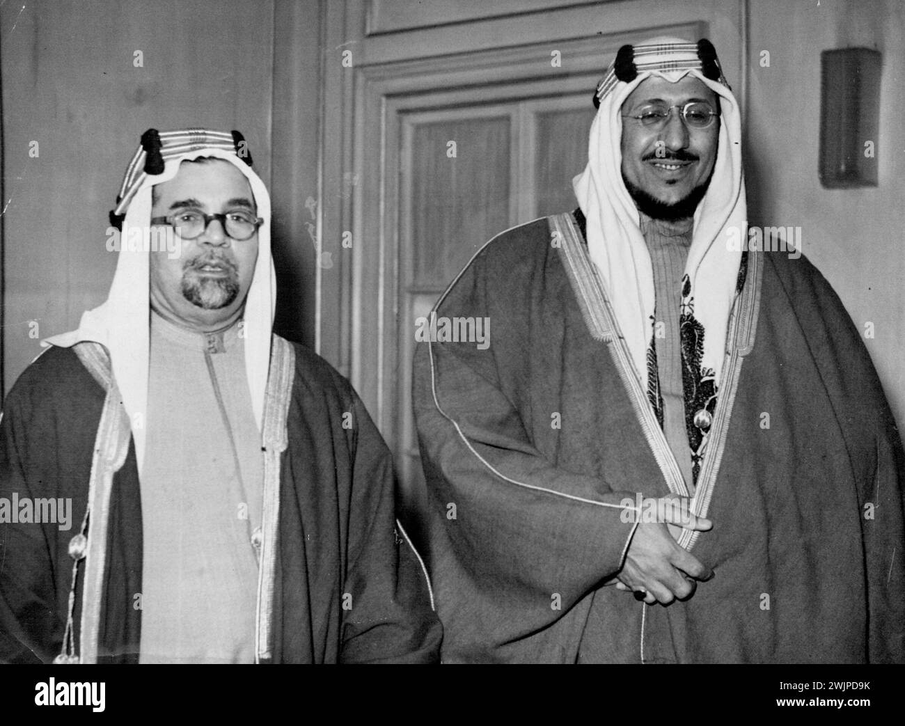 The Emir Saud (right) photographed with Sheikh Hafiz ***** K.C.V.O., Saudi Arabian minister in London, at the Dorchester hotel, London today (Thursday). The Emir Saud, crown prince of Arabia, arrived in London by air today from the United States of America. He came in president's own plane after having spent a month as Mr. Truman's guest. Although his visit is described as semi official, It is thought that the crown prince will undoubtedly see Mr. Bevin, the foreign secretary. A trust oriental, the Emir knows no English, wears colorful flowing rooms, and his an attendant bodyguard ***** wi ... Stock Photo