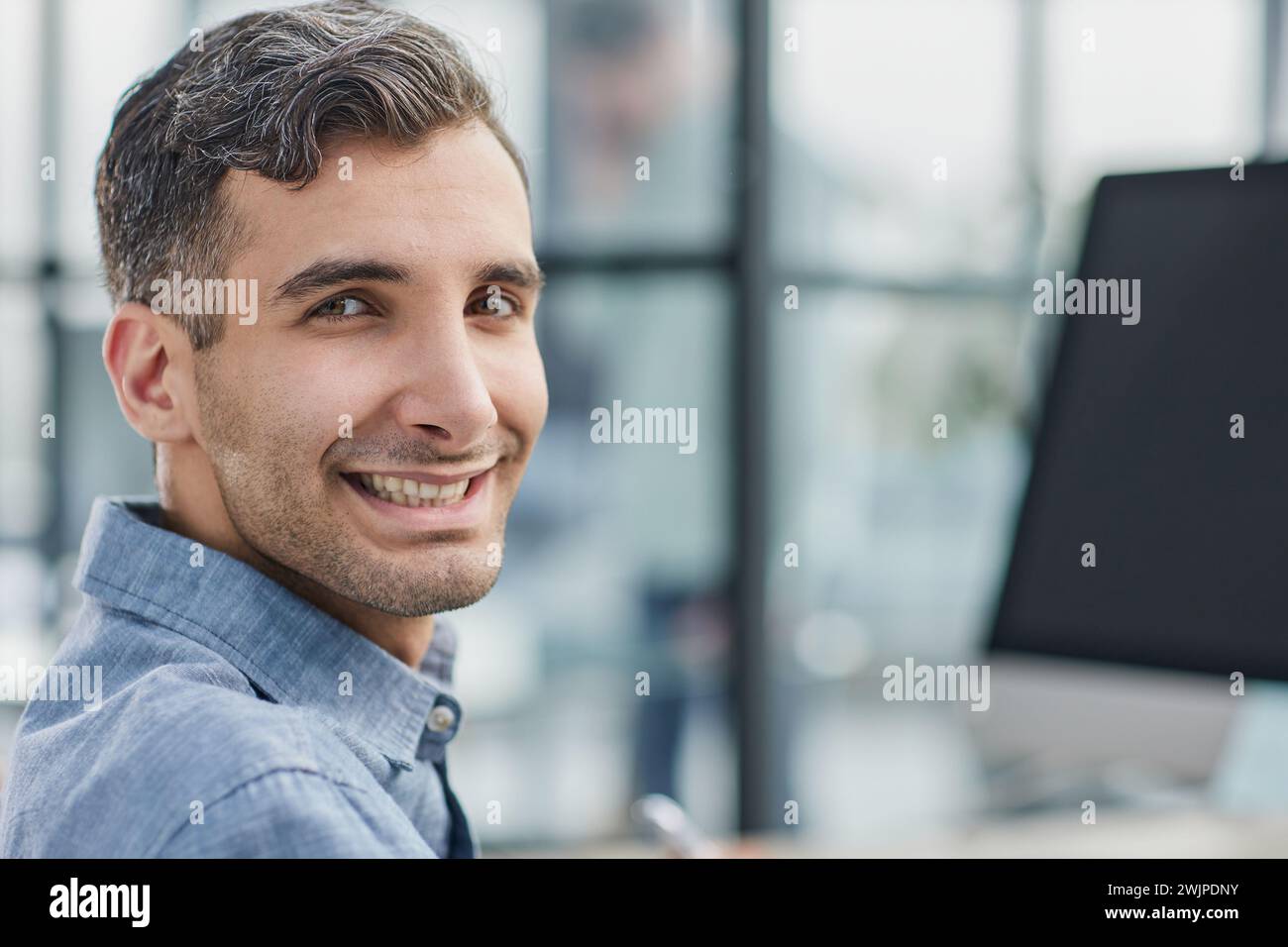 happy freelancer looking at camera during making project for remote job making notes. Stock Photo