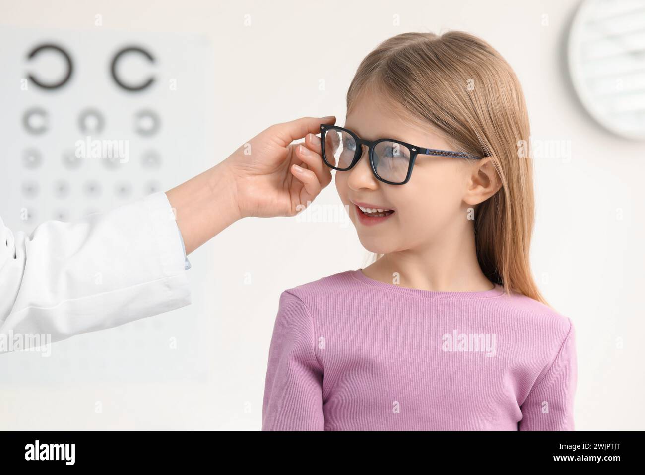 Infant Vision Testing Vision testing. Little girl trying glasses at ophthalmologist office ...