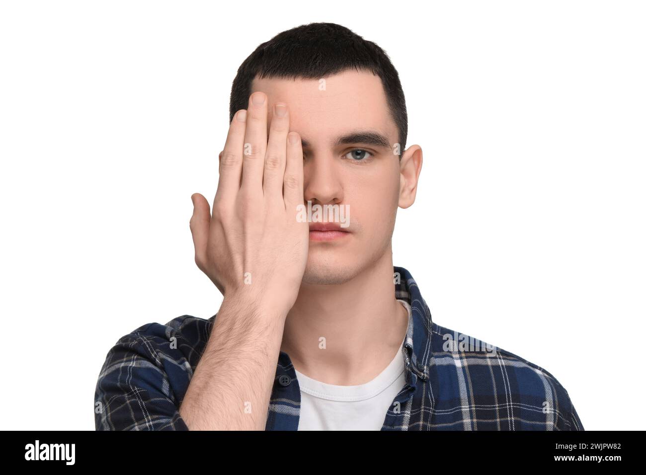 Young man covering his eye on white background Stock Photo - Alamy