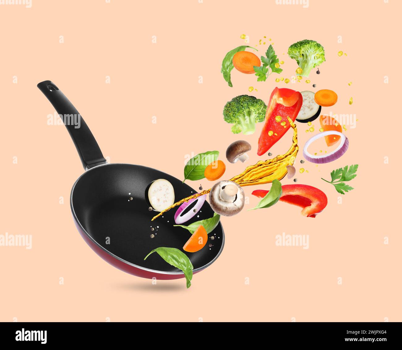 Different vegetables, oil, frying pan in air on pale coral background Stock Photo