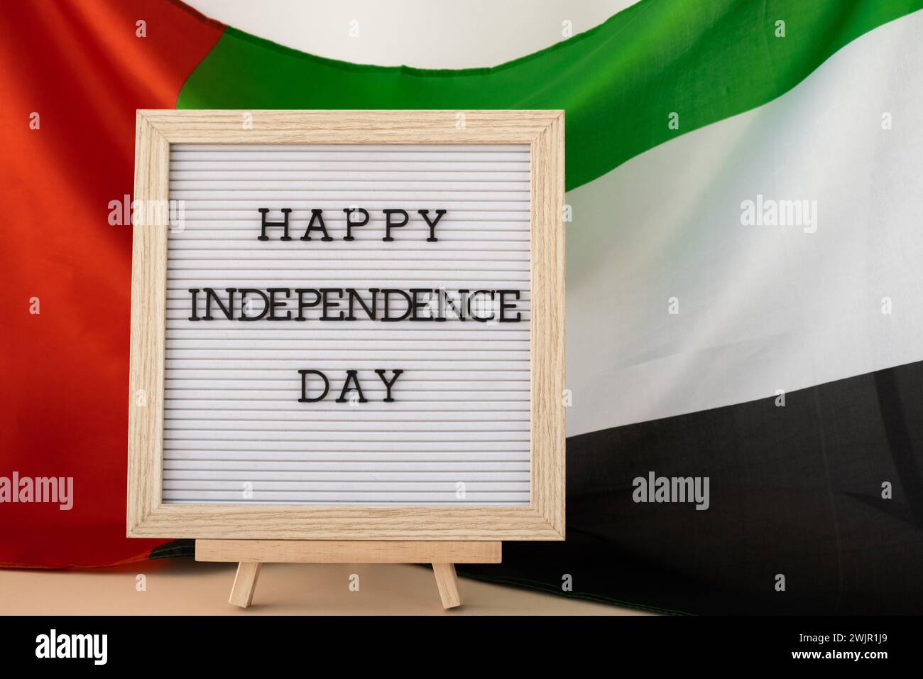 HAPPY INDEPENDENCE DAY text frame on United Arab Emirates waving flag ...