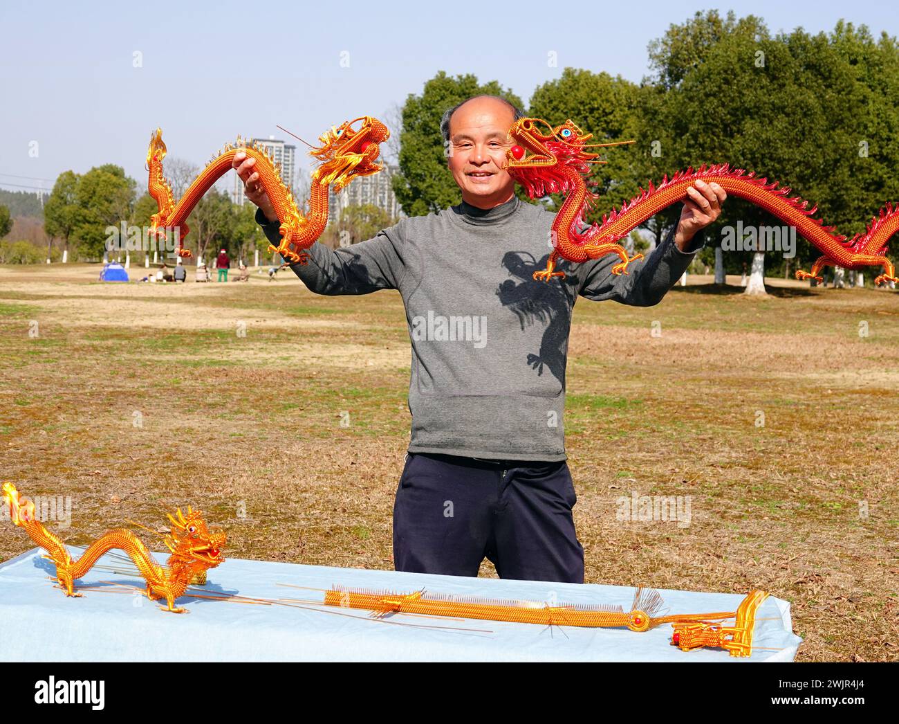 Folk artist Rong Zhongzhong creates and displays handicrafts such as an aluminum zodiac dragon to celebrate the Spring Festival of the Year of the Dra Stock Photo