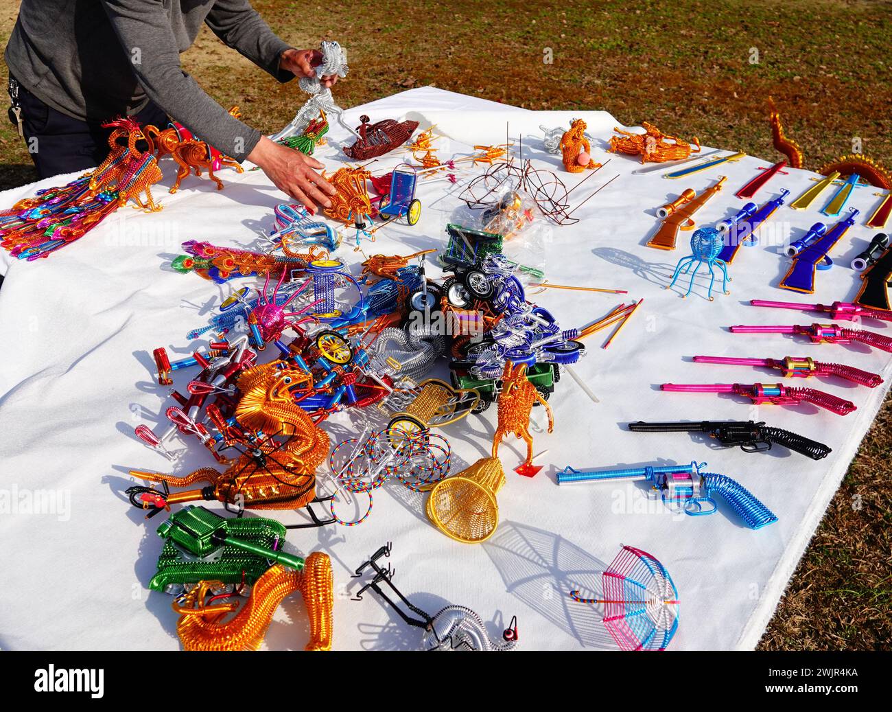 Folk artist Rong Zhongzhong creates and displays handicrafts such as an aluminum zodiac dragon to celebrate the Spring Festival of the Year of the Dra Stock Photo