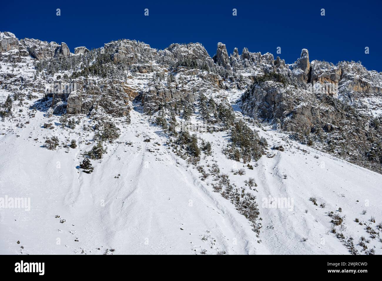 Dejection cones and erosion channels on the south face of the Pineta Valley on a winter morning (Ordesa y Monte Perdido NP, Huesca, Aragon, Spain) Stock Photo