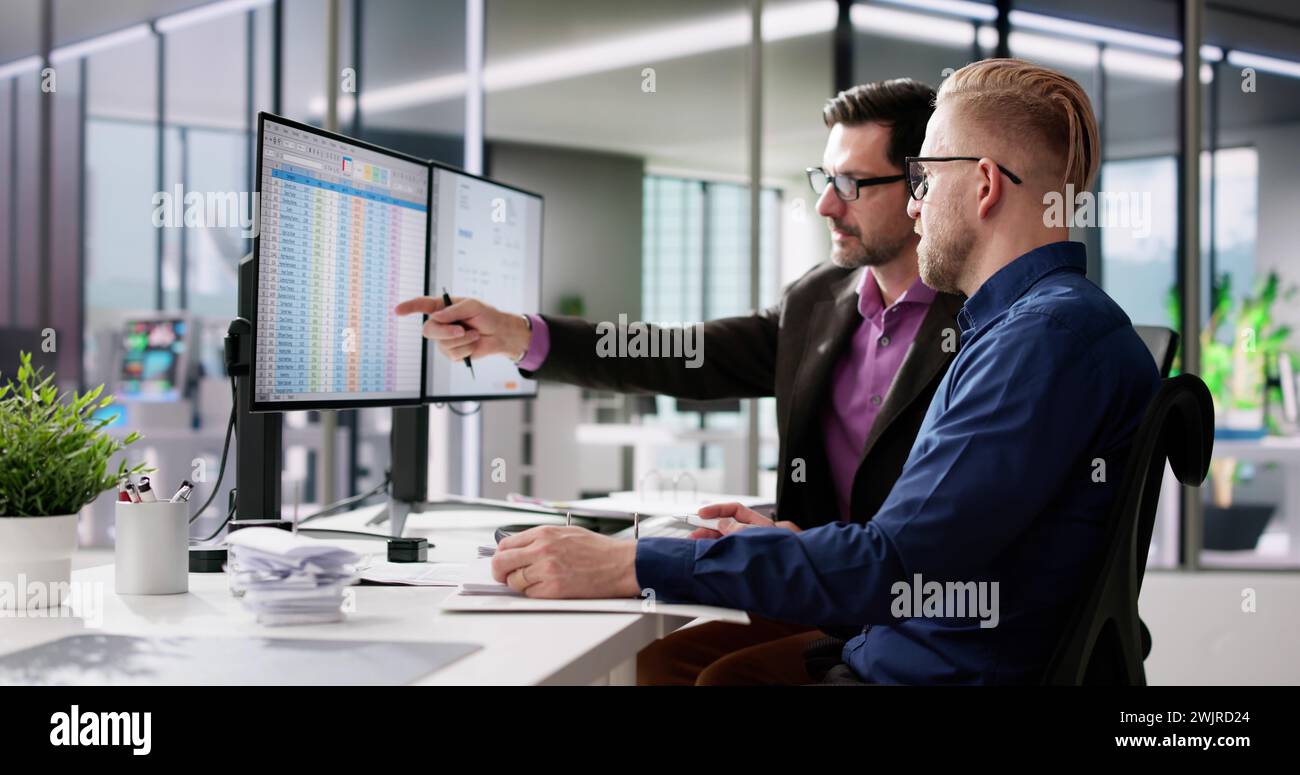 Using Corporate Invoice Spreadsheet On Computer Monitors Stock Photo