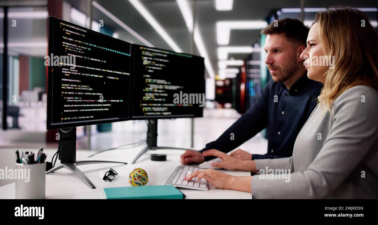 Coder Using Computer At Desk. Web Developer Stock Photo