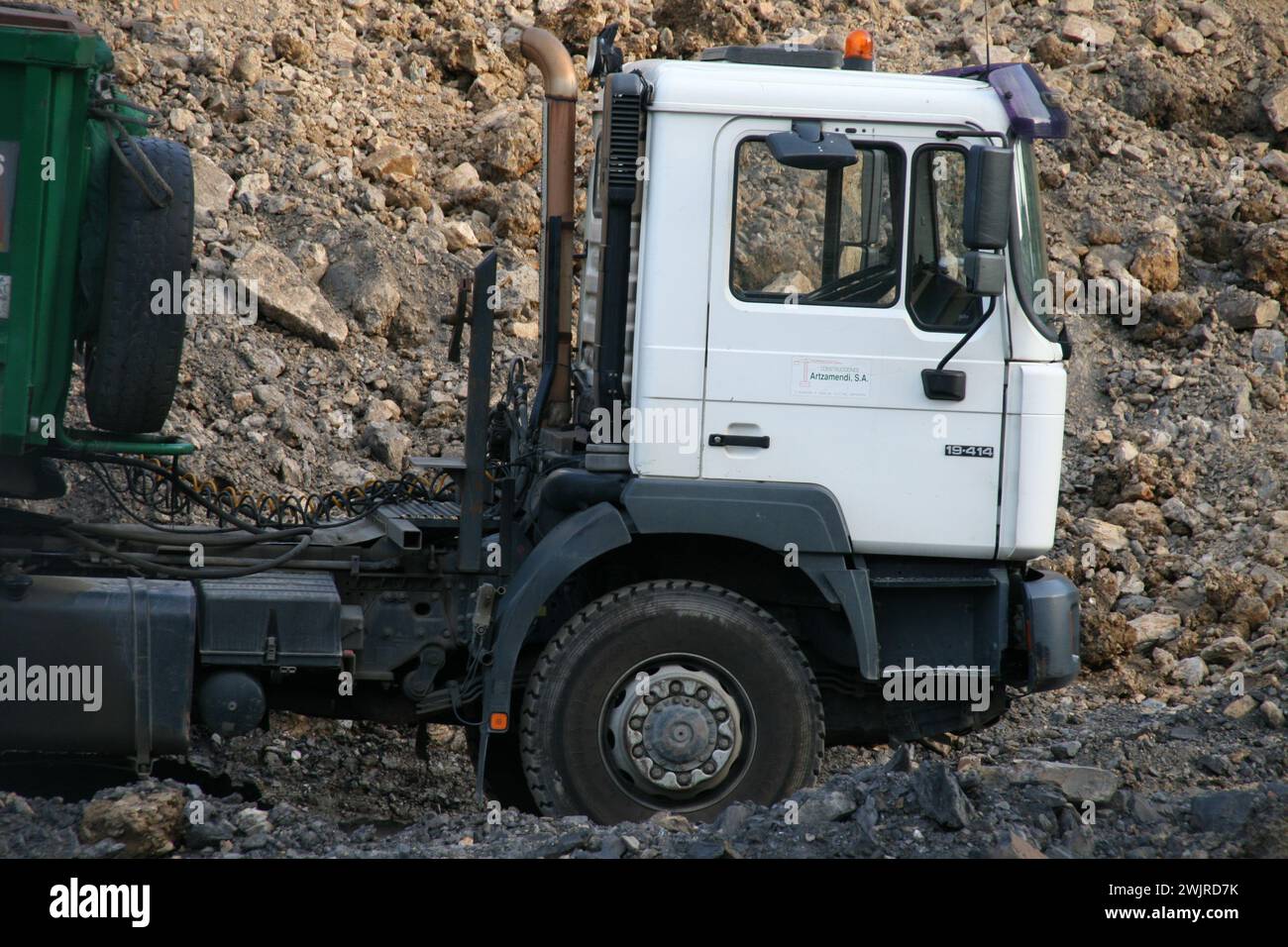 Fully Loading A fully loaded dump truck with its loader in a muddy location Stock ...