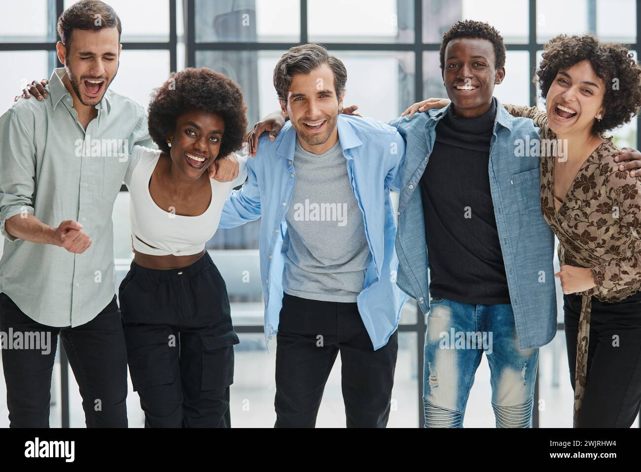 a group of successful business diverse people in the office stands ...